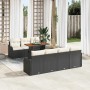 Schwarzes 8-teiliges Garten-Sofa-Set aus Poly Rattan mit Tisch und Kissen.