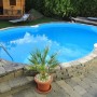 Summer Fun Stahlwandpool COLORADO Achtform, teilversenkt. Pool mit Leiter und Steinumrandung.