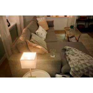 Philips Hue LED-Lampe E14, 470 lm, 5,7 W in Wohnzimmer-Szene.