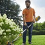 Mann nutzt Stiga Akku-Rasentrimmer GT 500e im Garten für präzise Rasenkanten.