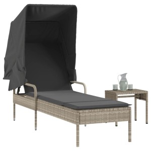 Hellgraue Poly Rattan Sonnenliege mit Dach und Tisch für den Garten.