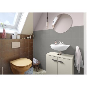 Badezimmer mit Fliesenlack in Granit: Wandfliesen grau, Bodenfliesen braun, Waschbecken und Toilette.