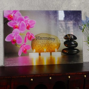 Glasbild Harmony 40x60cm mit Orchideen, Steinen und Kerzen als Wanddekoration.