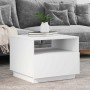 Weißer Couchtisch aus Holzwerkstoff mit offenem Fach, modernem Design und LED-Beleuchtung, dekoriert im Wohnzimmer.