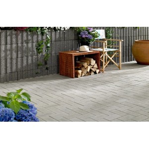 Graues Rechteckpflaster 20x10x6 cm auf Terrasse mit Gartenmöbeln und Bepflanzung.