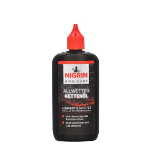 Nigrin Bike-Care Allwetter Kettenöl in schwarzer Flasche mit roter Spitze.