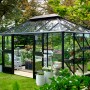 Juliana Gewächshaus Grand Oase 13 in Anthrazit, 13 m², mit Pflanzen im Garten.