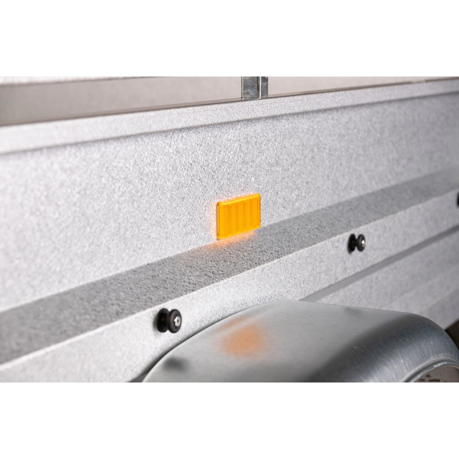 Detailansicht: Seitenwand mit gelbem Reflektor am Stema Anhänger Variolux 850.