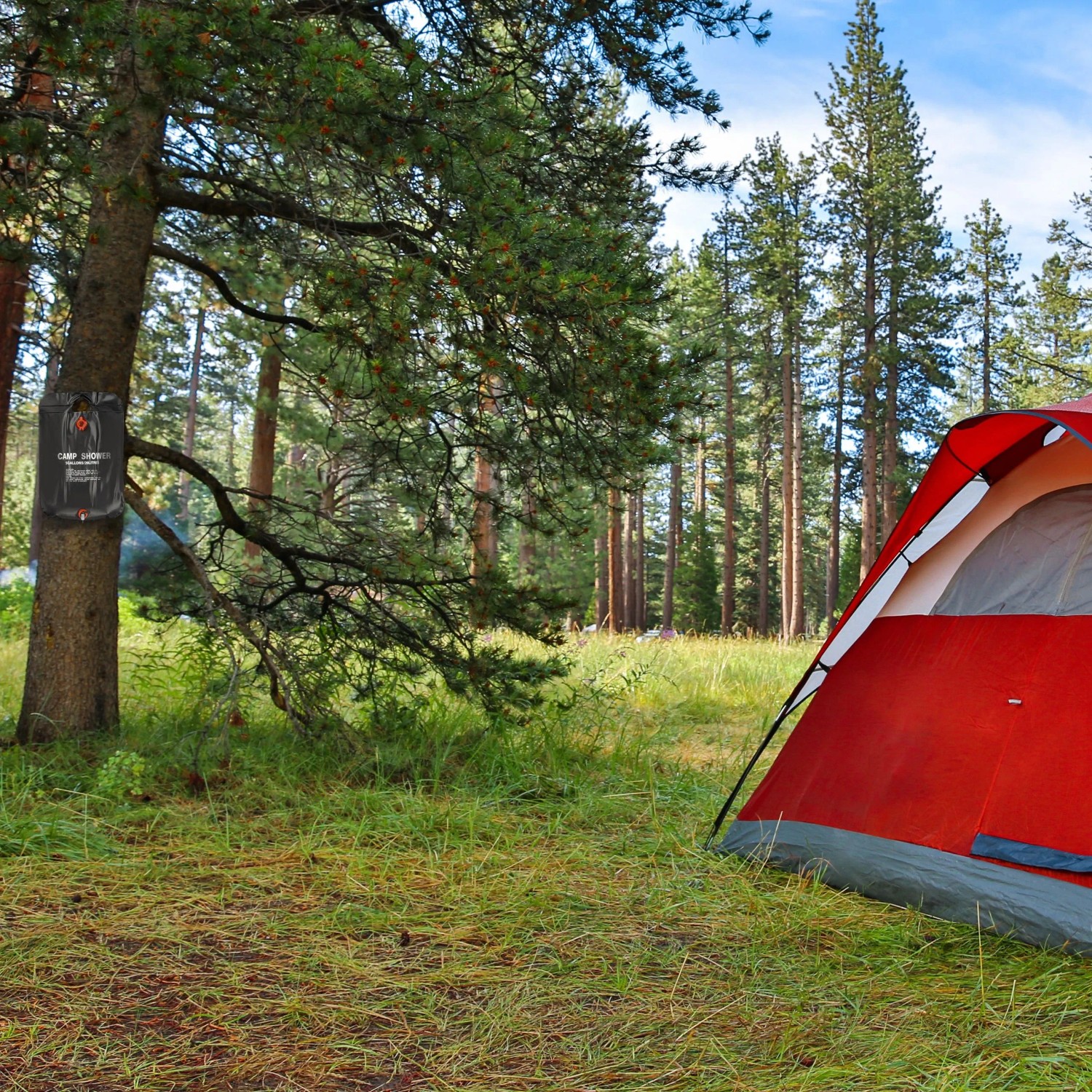 Aufgebautes Campingzelt mit Relaxdays Campingdusche am Baum befestigt im Outdoor Bereich.
