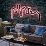 Paulmann FlexLED RGB Set als leuchtende Skyline an dunkler Backsteinwand.