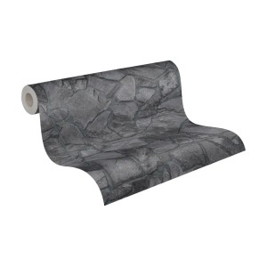 A.S. Création Vliestapete in Schwarz mit Bruchsteinmauer Design, gerollt dargestellt.
