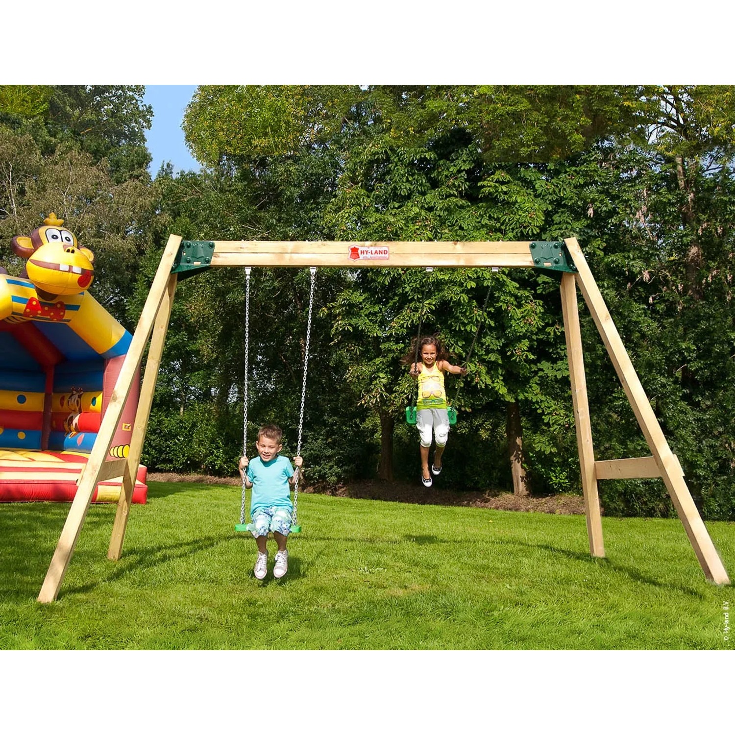 Hy-Land Doppelschaukel aus Kiefernholz mit zwei Kindern im Garten.