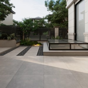 Verlegte graue Feinsteinzeug Terrassenplatten Streetline 60x60 cm im Garten.