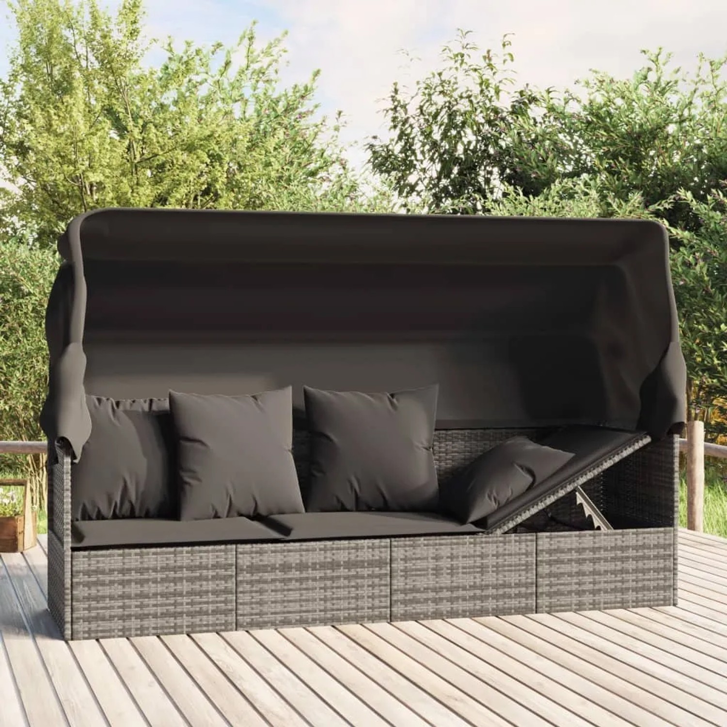 Graues Outdoor-Loungebett mit Dach und Kissen aus Polyrattan.