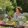 Frau benutzt Gardena EasyPump Pumpsprüher 1 l zum Bewässern von Pflanzen im Garten.