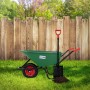 Grüne ECD Germany Gartenschubkarre (100L) mit Luftrad und Schaufel im Garten.