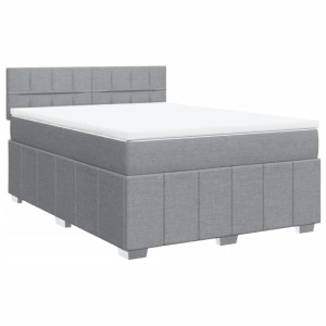 Hellgraues Boxspringbett 140x190 cm aus Stoff mit gepolstertem Kopfteil und weißer Matratze.