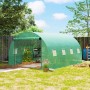 Grünes Outsunny Gewächshaus mit Tomatenpflanzen und Erdankern im Garten.