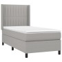 Helles Boxspringbett 90x200 cm mit Stoffbezug und Matratze für erholsamen Schlaf.