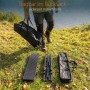 Person trägt Tragetasche mit Campingtisch am See. Zerlegter Aluminium Klapptisch und Tasche liegen auf Gras.