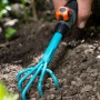 Gardena combisystem-Blumenkralle im Einsatz zum Auflockern der Erde im Garten.