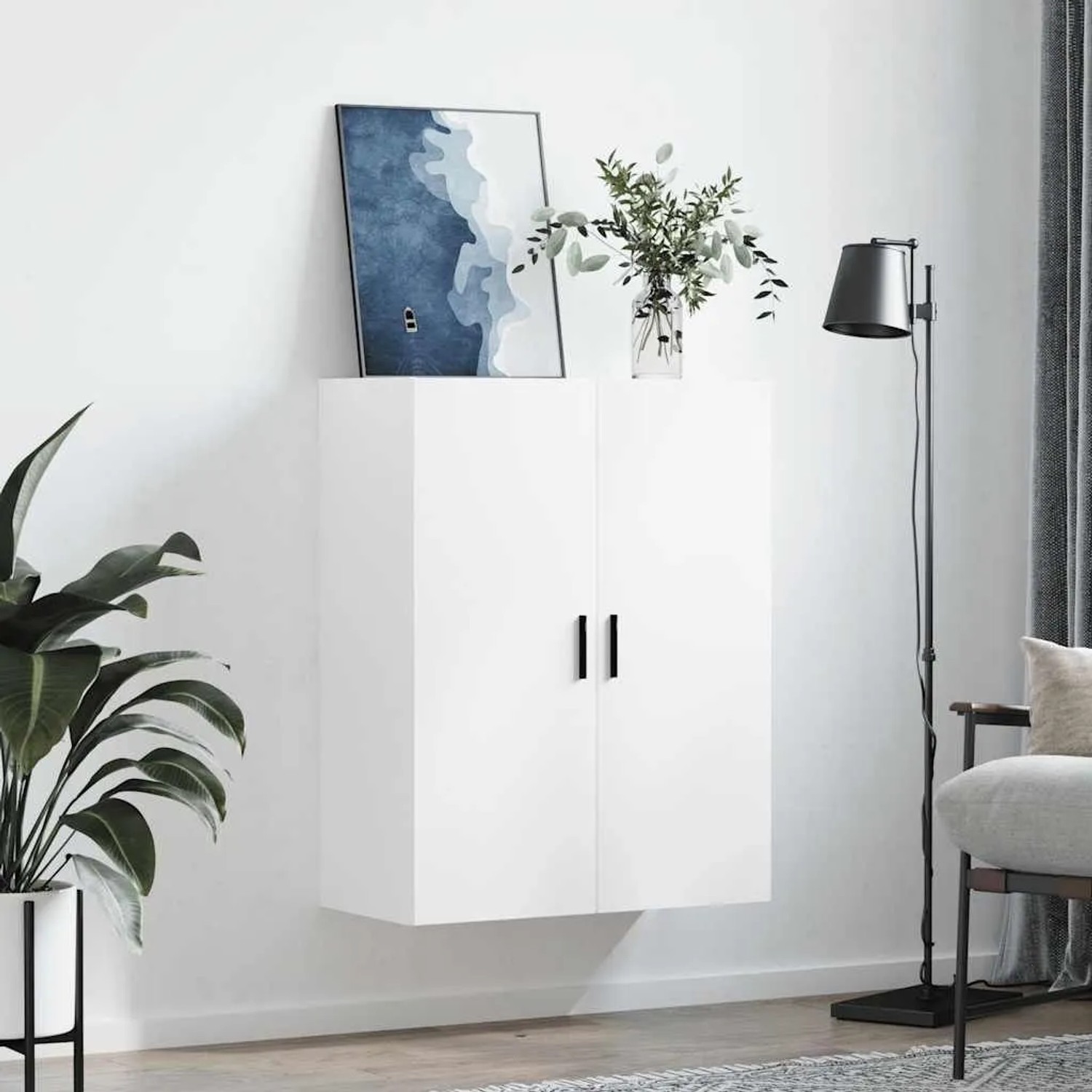 Weißer Wohnzimmerschrank mit zwei Türen und schwarzen Griffen, an weißer Wand montiert. Modernes Design.