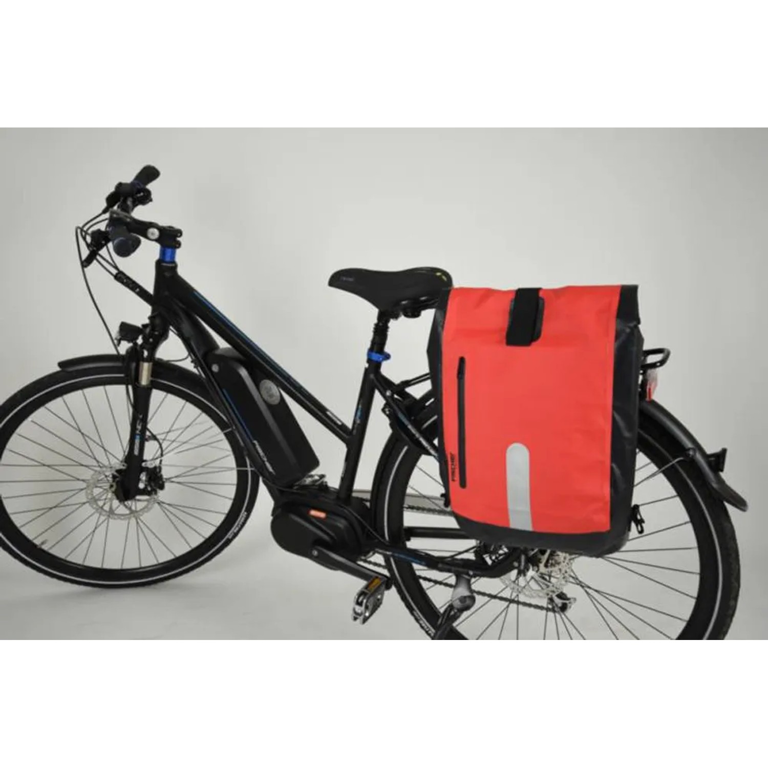 Fischer Fahrrad-Gepäckträgertasche, wasserdicht, schwarz-orange, am Fahrrad befestigt.