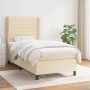 Cremefarbenes Boxspringbett 100x200 cm mit Stoffbezug und Matratze.