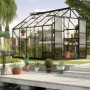 Vitavia Gewächshaus Uranus 8300, schwarzer Rahmen, 8,3 m², mit Pflanzen im Garten.