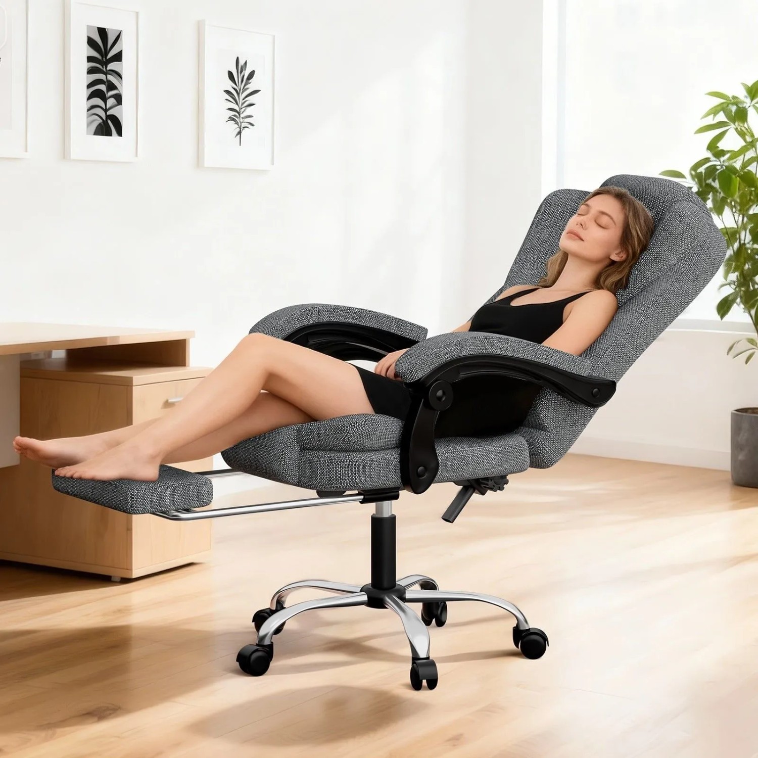 Grauer ergonomischer Bürostuhl mit hoher Rückenlehne und ausziehbarer Fußstütze, ideal zum Entspannen.