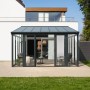 Home Deluxe Wintergarten AMARIS, anthrazitfarbener Pavillon mit Glasfronten und Sitzmöbeln.