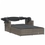 Graue Doppel-Sonnenliege aus Rattan mit Dach und Auflagen für den Garten.