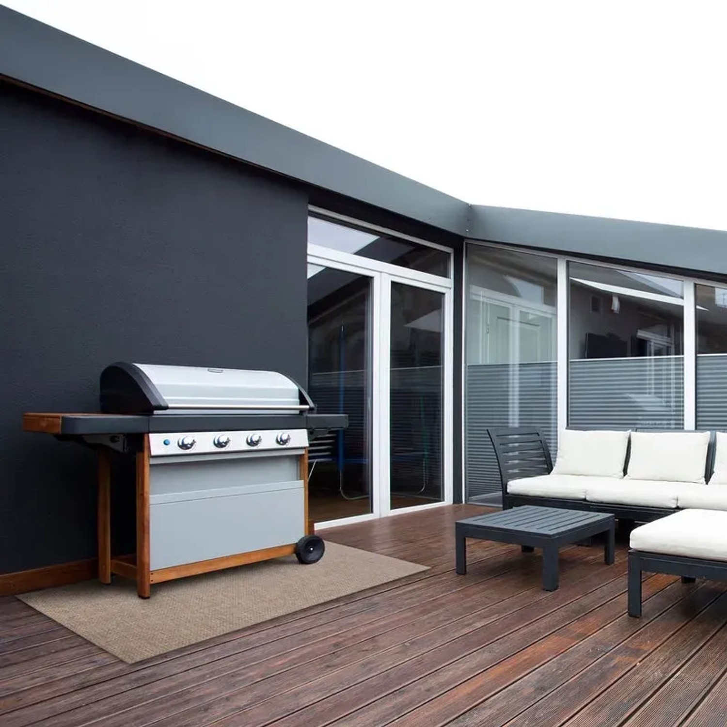 Wetterfester KARAT Outdoor Teppich Trani 180x450 cm auf Terrasse mit Grill und Gartenmöbeln.