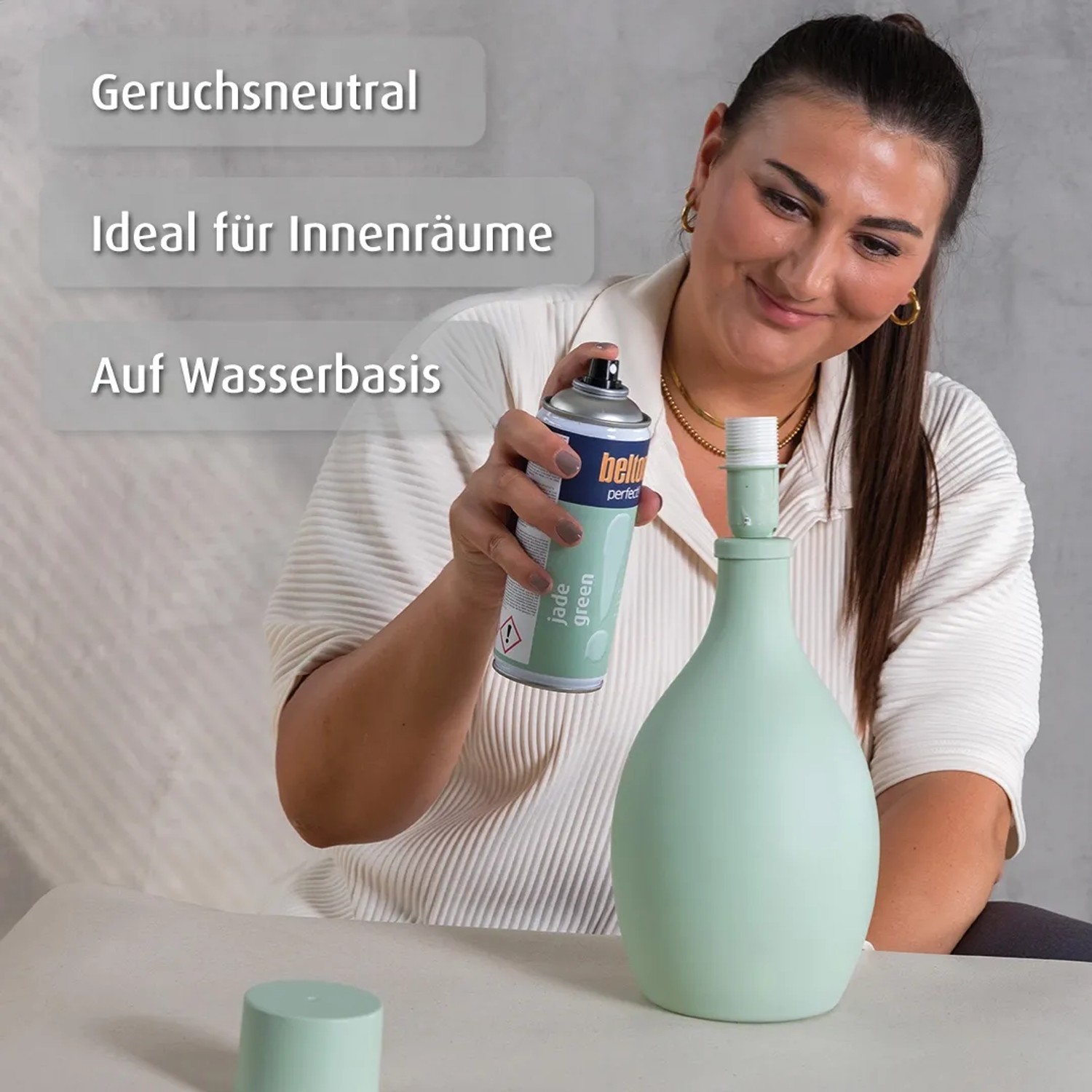 Frau sprüht Vase mit belton Buntlack Perfect Jade Green seidenmatt.