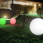 Weiße Globo TOULA Außen-Kugelleuchte mit Erdspieß im Garten.