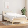Cremefarbenes Boxspringbett (90x190 cm) mit Matratze und Stoffbezug.