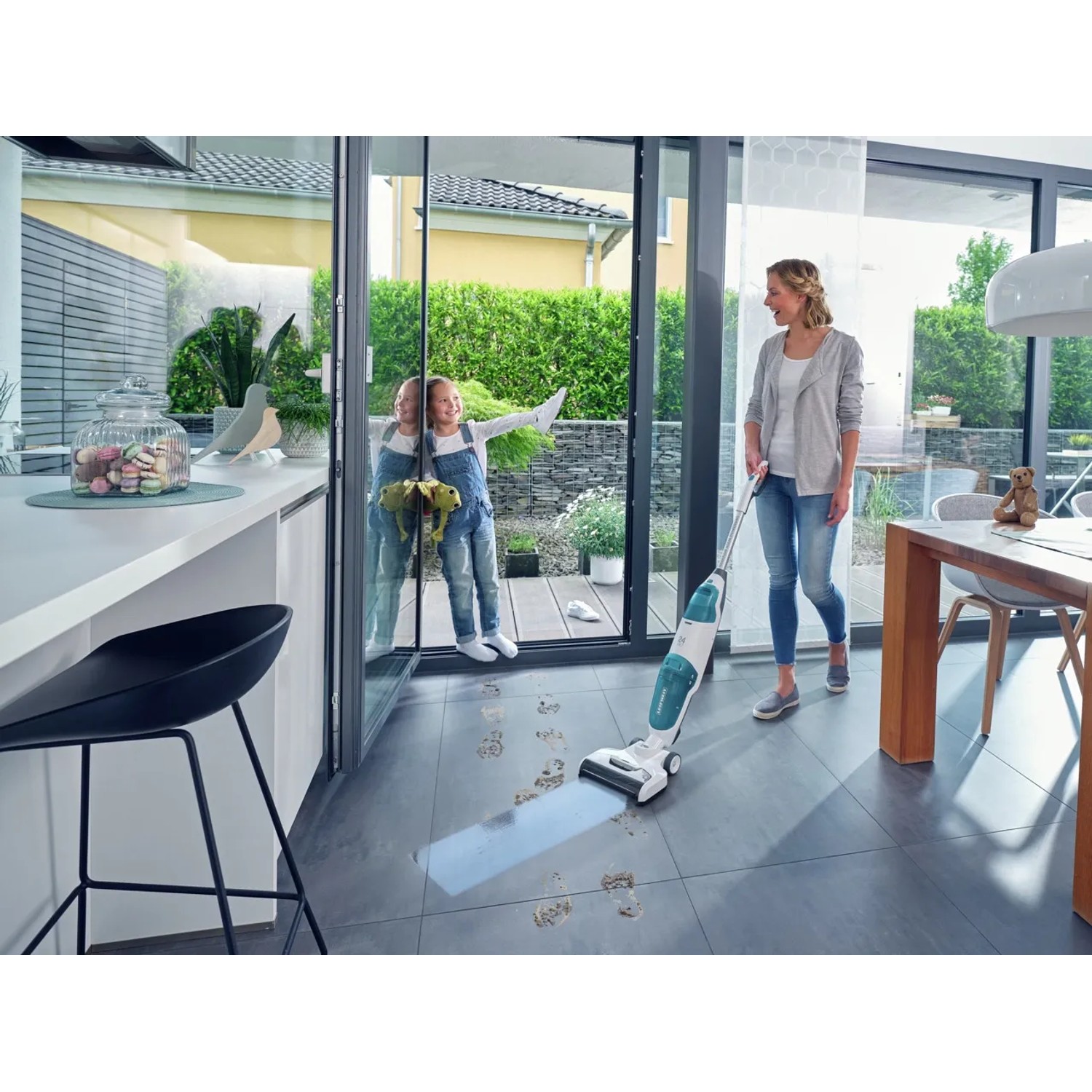 Frau reinigt Fliesenboden mit Leifheit Akku-Saugwischer Regulus Aqua PowerVac.