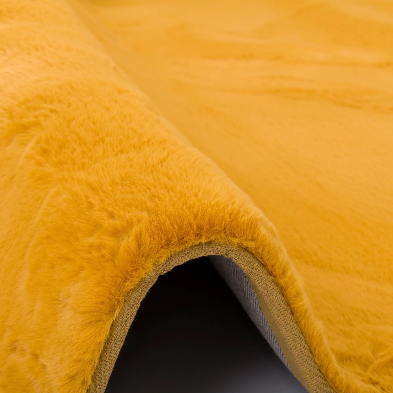 Detailaufnahme: Curryfarbener Pergamon Luxus Fellteppich, superweich und flauschig.