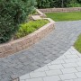 Diephaus Pflastersteine Collo Basalt, 14x14x7 cm, verlegt als Gartenweg mit Rasenfläche.