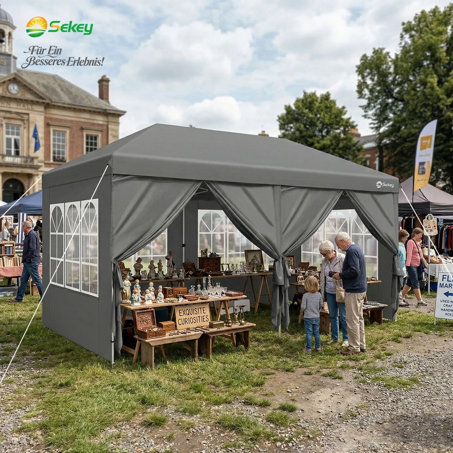 Grauer Sekey Faltpavillon 3x6 m mit Seitenteilen und Fenstern auf einem Markt. Wasserdichter Pop-Up Pavillon für Events.
