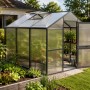 Rechteckiges KGT Gewächshaus Anthrazit-Grau 7,53 m² im Garten mit Pflanzen, offenem Dachfenster und Tür.