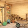 Innenansicht: Lasita Gartenhaus Felix 3, unbehandelt, mit Regalen, Gartengeräten und Schubkarre.