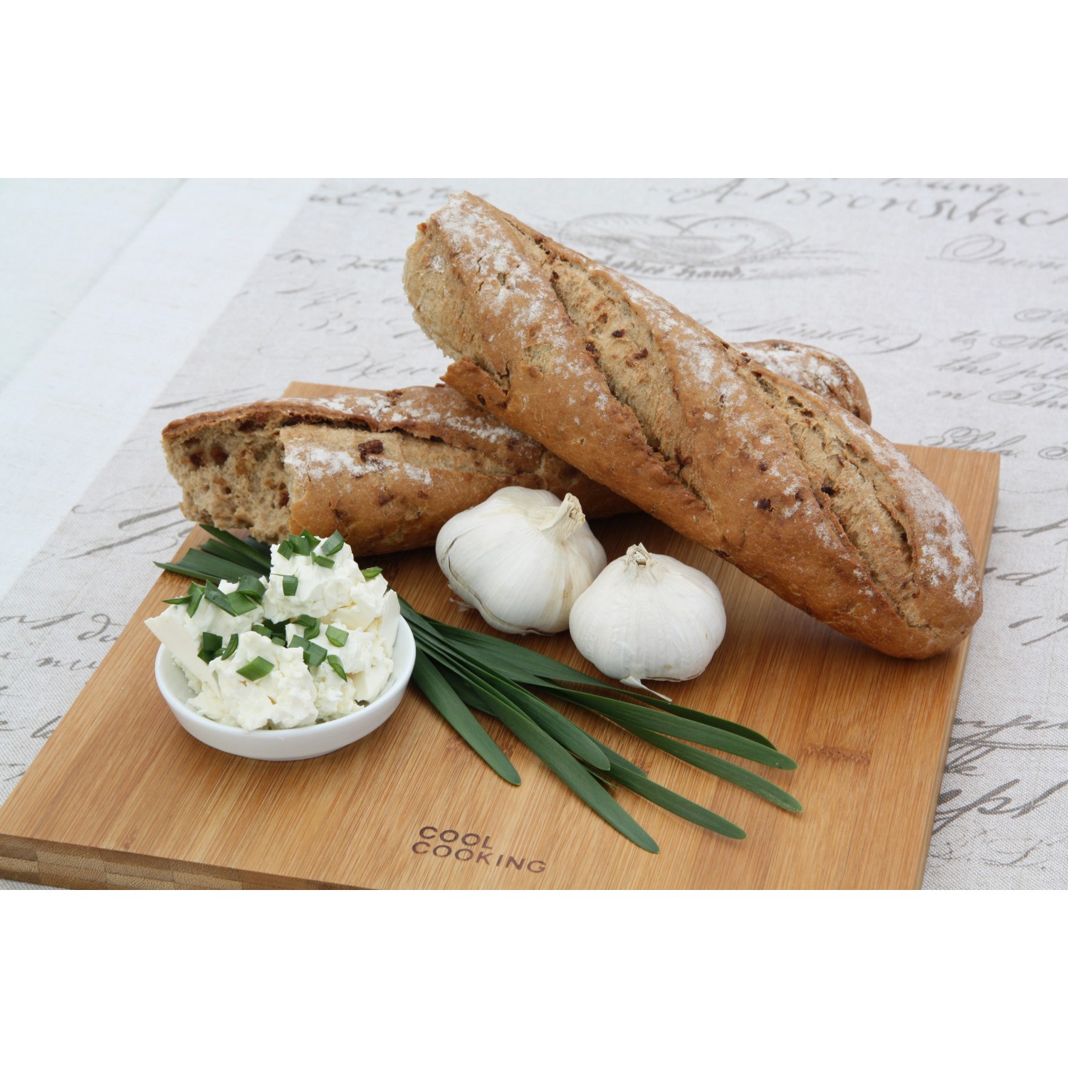 Brot, Knoblauch und Kräuterquark auf Holzbrett. Garten-Knofi als Zutat.