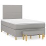 Hellgraues Boxspringbett 120x200 cm mit Matratze, Kopfteil und Bank.