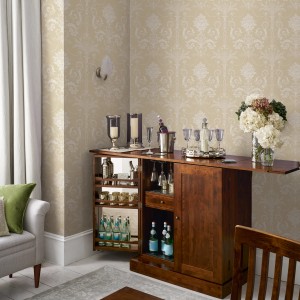 Laura Ashley Vliestapete Josette Linen im Wohnraum mit Bar und Dekoration.