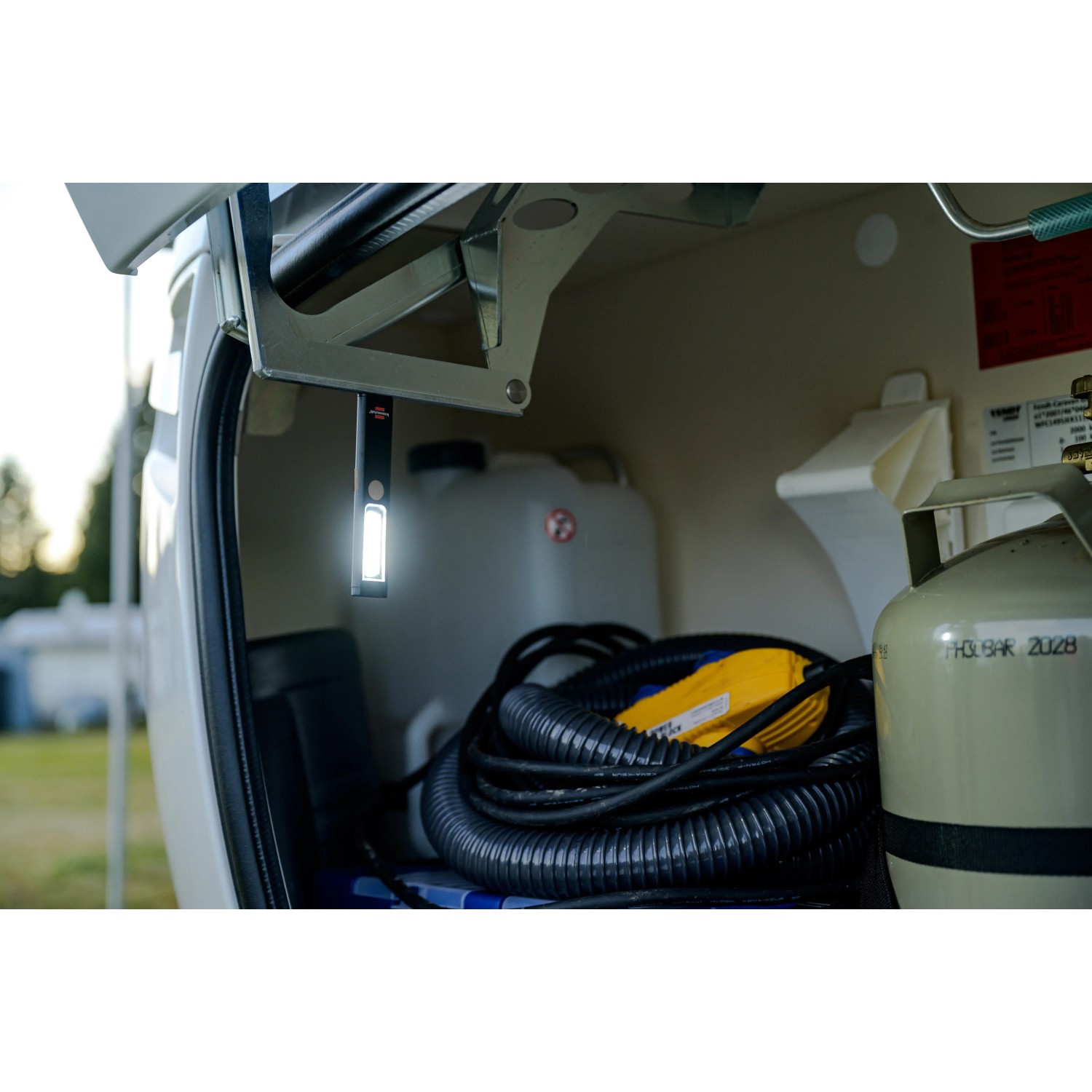 Brennenstuhl LED-Akku-Handleuchte PL 200 AC im Einsatz, befestigt mit Magnet im Kofferraum eines Campers.