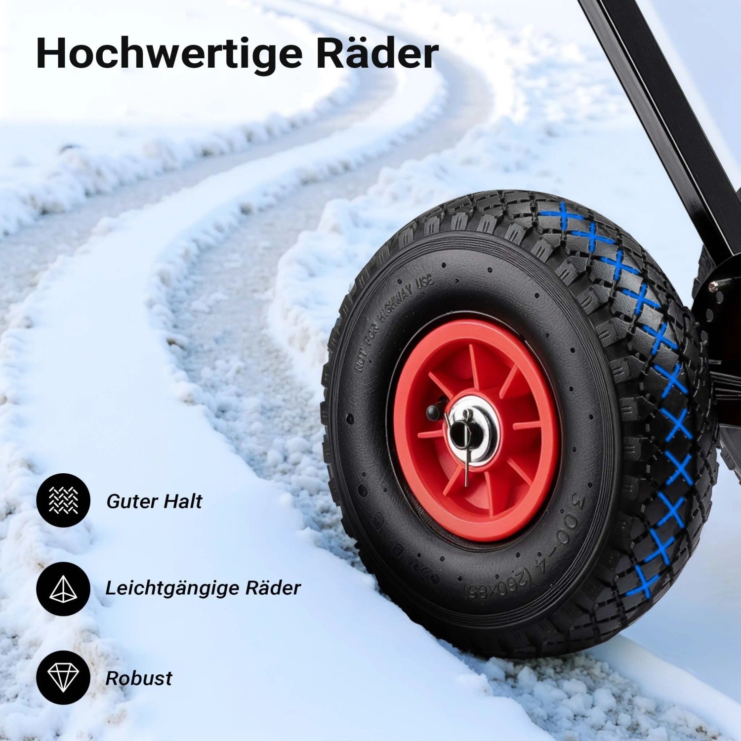 Detailansicht des robusten, schwarzen Pneumatikrads eines Wiltec Schneeschiebers auf verschneitem Weg. Rotes Rad, guter Halt.