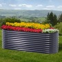 Floraworld Hochbeet Welle, 240 cm, anthrazit, bepflanzt mit roten, gelben und weißen Blumen im Garten.