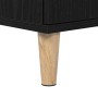 Detailaufnahme: Schwarzer Waschbeckenunterschrank mit Eichen-Optik und Holzbein.