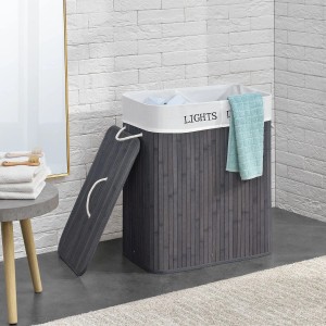 Grauer Juskys Bambus Wäschekorb Curly (100L) mit Deckel, Wäschesack und Tragegriffen.